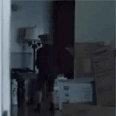 Person In Room With Boxes And Lamp GIF