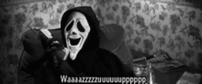 Person In Scary Mask Sitting In Chair GIF