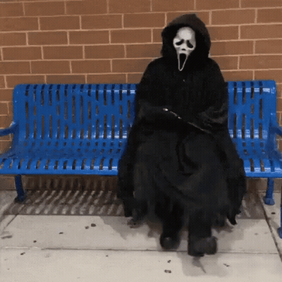 Person In Scream Costume Sitting On Blue Bench GIF