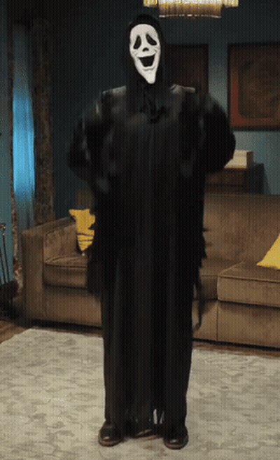 Person In Scream Costume Standing In Living Room GIF