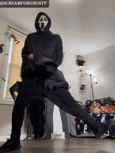 Person In Scream Mask Dancing By Window GIF