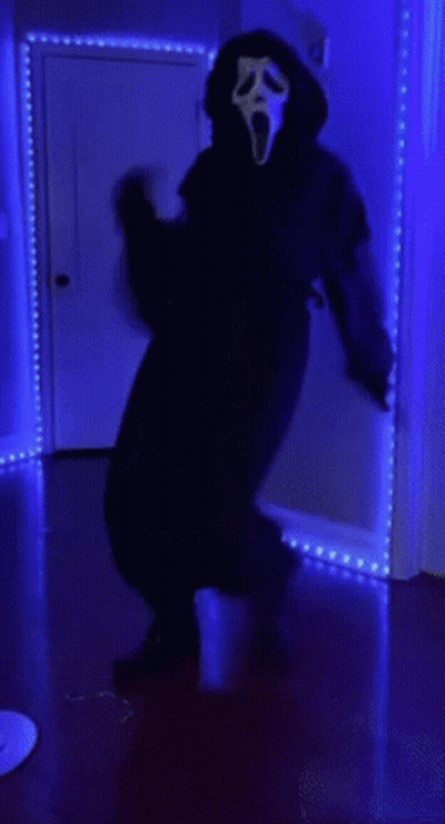 Person In Scream Mask In Dark Room GIF