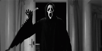 Person In Scream Mask Standing By Door GIF