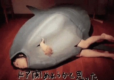 Person In Shark Costume Lying On Floor GIF
