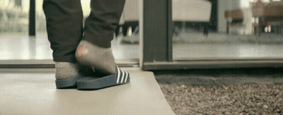 Person In Slippers Standing On Tile Floor GIF