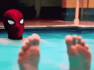 Person In Spiderman Mask Floating In Pool GIF