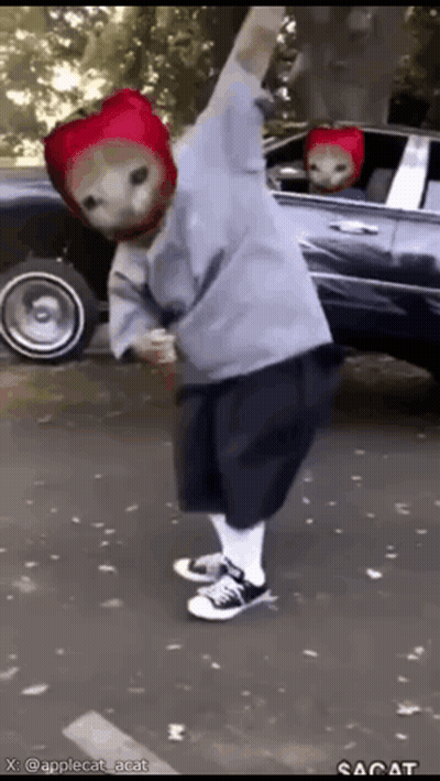 Person In Strawberry Hat Standing In Front Of Car GIF