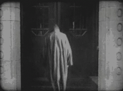 Person In Striped Robe Walking Through Doorway GIF
