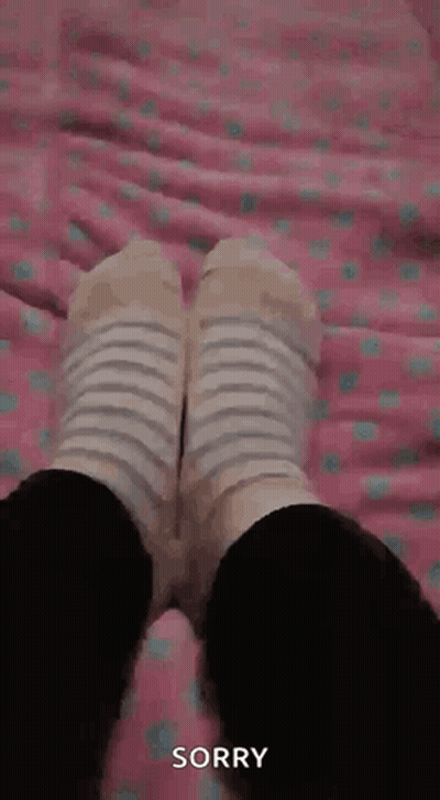 Person In Striped Socks Lying On Bed Sorry GIF
