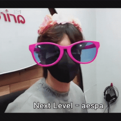Person In Sunglasses And Mask Saying Next Level Aespa GIF