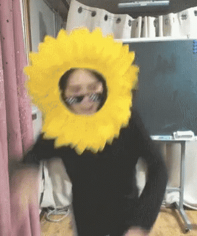 Person In Sunglasses And Sunflower Headpiece GIF