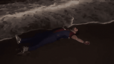 Person In Superhero Costume Lying On Ground GIF