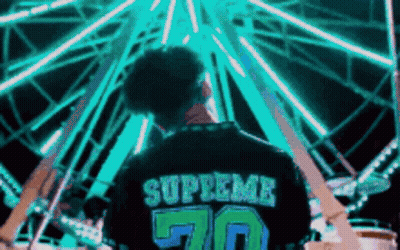Person In Supreme Shirt By Ferris Wheel GIF