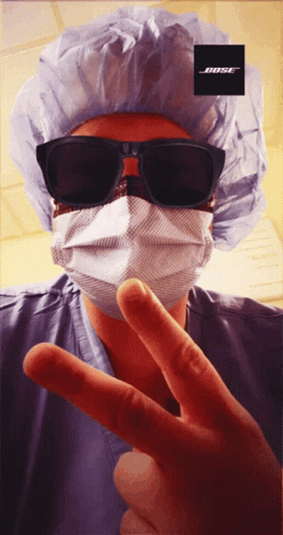 Person In Surgical Mask And Sunglasses With Bose Logo GIF