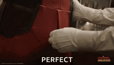 Person In White Gloves Holding Red Superhero Suit GIF