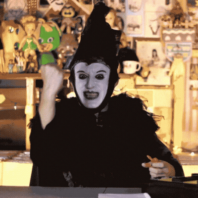 Person In Witch Costume Holding Pen GIF