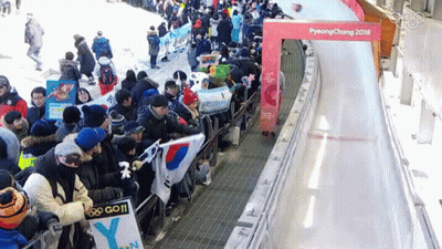 Person In Yellow Fila Shirt Kneeling On Sled GIF