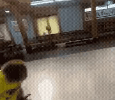 Person In Yellow Jacket Standing In Room GIF