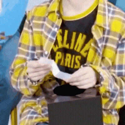 Person In Yellow Plaid Shirt And Black Paris Shirt GIF