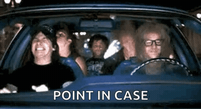 Person In Yellow Shirt Standing In Front Of Curtain GIF