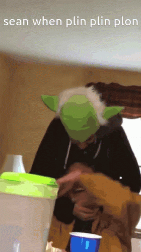 Person In Yoda Hat Holding Blue Cup GIF