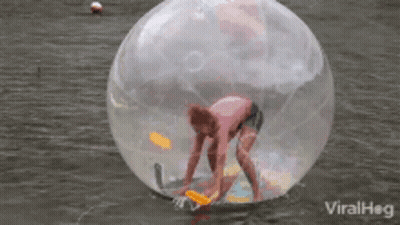 Person Inside Clear Ball Floating In Water GIF