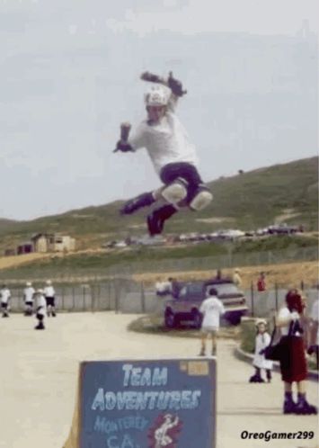 Person Jumping In Front Of Team Adventures Sign GIF