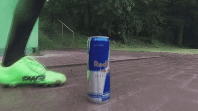 Person Kicking Red Bull Can On Sidewalk GIF