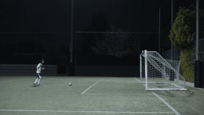 Person Kicking Soccer Ball Into Goal GIF