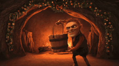 Person Kneeling In Front Of Fireplace With Candy Canes GIF