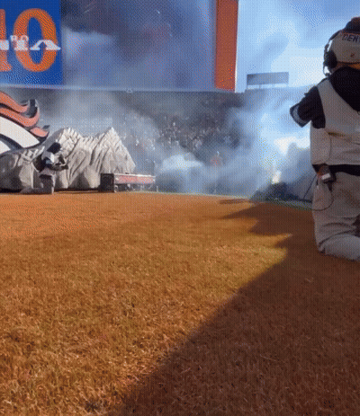 Person Kneeling In Front Of Sign That Says 10 GIF