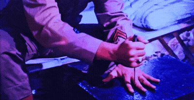 Person Kneeling In Purple Shirt GIF