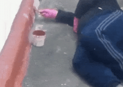 Person Kneeling Painting Wall With Brush GIF