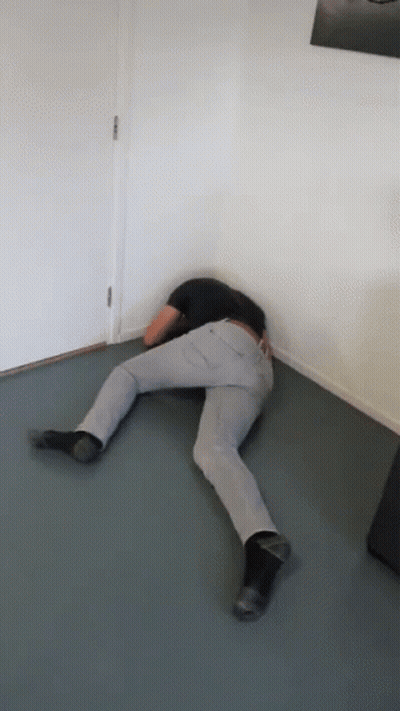 Person Laying Floor Head In Corner GIF