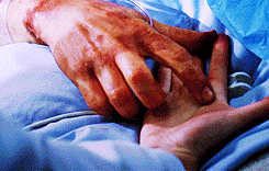 Person Laying In Hospital Bed Holding Hands GIF