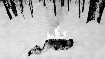 Person Laying In Snow With Fire On Head GIF