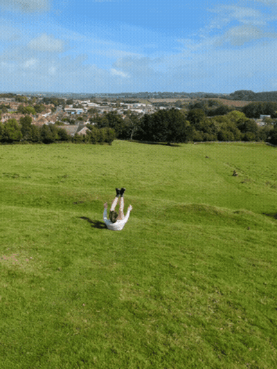 Person Laying On Back In Grass GIF