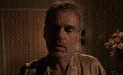 Person Laying On Bed In Blue Light Bedroom GIF