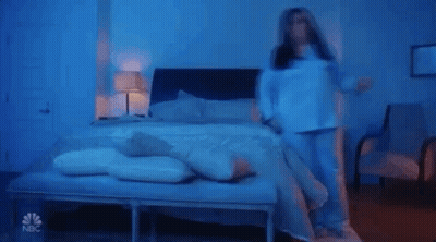Person Laying On Bed In Blue Light GIF