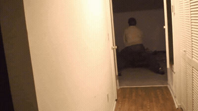 Person Laying On Bed In Hallway GIF