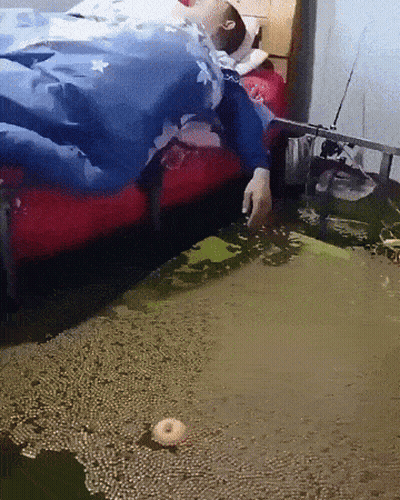 Person Laying On Bed In Puddle Of Water GIF