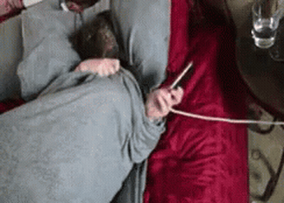 Person Laying On Bed With Cell Phone In Ear GIF