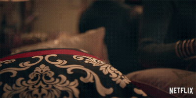Person Laying On Bed With Netflix Logo GIF
