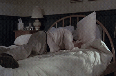 Person Laying On Bed With Pillow On Face GIF