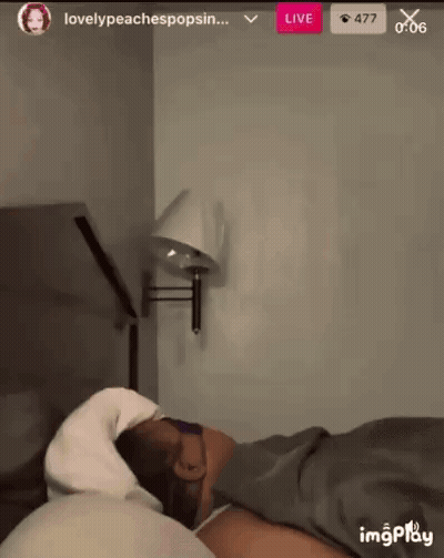 Person Laying On Bed With Wall Lamp GIF