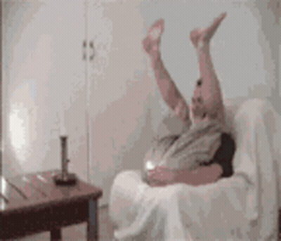 Person Laying On Couch With Legs In Air GIF