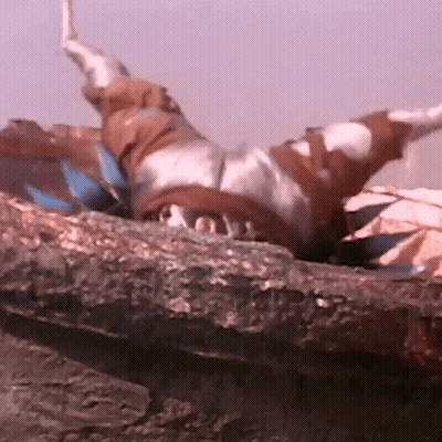 Person Laying On Rock With Arms Outstretched GIF