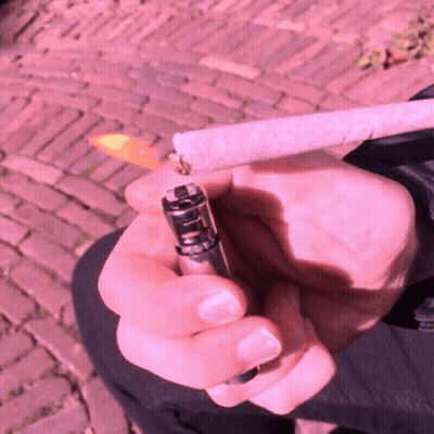 Person Lighting Cigarette With Clipper Lighter GIF