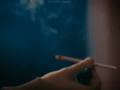 Person Lighting Cigarette With Lighter GIF