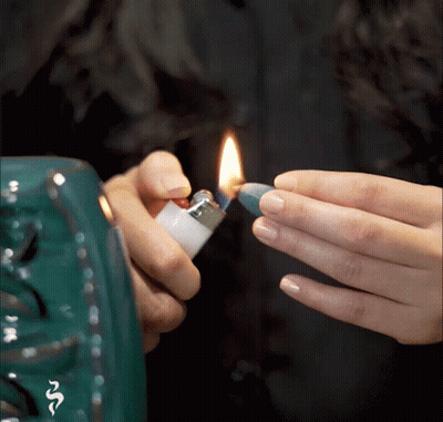 Person Lighting Lighter With Snake GIF